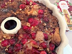 a baked dish with cranberry sauce and nuts on top, ready to be eaten