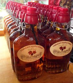 several maple syrup bottles lined up on a table