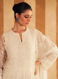 Step into refined elegance with the ivory new embroidered kurta, perfectly paired with luxurious silk pants and a delicate net embroidered dupatta. The kurta features intricate embroidery in soft ivory, adding a touch of sophistication. The silk pants offer a sleek, complementary finish, while the net dupatta, adorned with delicate embroidery, completes the ensemble with an ethereal charm. Ideal for both festive and formal occasions, this outfit effortlessly blends classic grace with contemporar Unstitched Off White Kurta With Sheer Dupatta, Unstitched Off-white Kurta With Sheer Dupatta, Off White Palazzo Set With Resham Embroidery, Elegant Off White Palazzo Set For Festive Season, Off White Elegant Palazzo Set For Festive Season, Elegant Off White Festive Palazzo Set, Festive Off White Elegant Palazzo Set, White Naqshi Sharara For Reception, White Palazzo Set With Intricate Embroidery