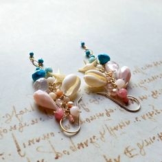 "Made to order. Important information on current production times may be found on the shop policies page or in the shop announcement. Now my long gemstone dangle earrings are available in a shorter version! *The first eight pictures are in gold filled, and the last is in sterling silver. ~ starfish, cowrie shells, sleeping beauty turquoise, pink Peruvian opal, rose quartz, larimar, turquoise, coral, grapefruit quartz, freshwater pearls, Swarovski crystals, angel skin coral ~ gold filled, rose go Turquoise Wire Wrapped Earrings For Beach, Turquoise Dangle Earrings Ocean-inspired, Turquoise Dangle Earrings With Ocean-inspired Style, Ocean-inspired Turquoise Dangle Jewelry, Artisan Turquoise Earrings For Beach, Whimsical Handmade Turquoise Earrings, Handmade Ocean-inspired Dangle Jewelry, Artisan Beach Jewelry Set With Earrings, Ocean-inspired Turquoise Jewelry With Ear Wire