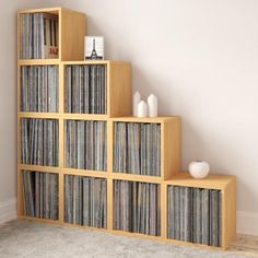 a set of wooden shelves filled with vinyl records