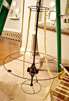 a table with some beads hanging from it's sides and a mirror in the background