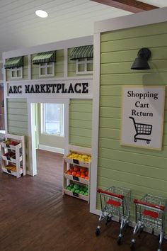 the inside of an art market with shopping carts and signs on the walls, along with baskets full of fruit