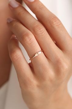 a woman's hand with a gold ring on it