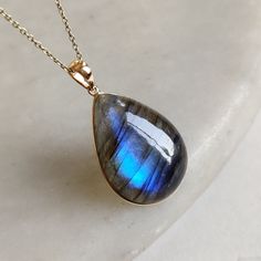 The pendents made with 14k solid gold.Gemstone used is absolutley natural and ethically sourced. The natural labradorite in pear shape ,cabachon cut with beautiful blue sheen is studded on it with its utmost precision. Gem :Labradorite Gem Weight: 22.85 carats Gem size and shape: 25×18 mm and Pear Metal: GOLD Purity: 14K (58.33%) approx Gold Weight: 0.80 grams Gross Weight: 5.37 grams Labradorite necklace pendant. These pendants are absolutely perfect for daily wear as they are light and definit Rare Eyes, Handmade Jewelry Box, Labradorite Necklace, Labradorite Necklaces, Bezel Pendant, November Birthstone, Statement Pendant, Blue Labradorite, Necklace Blue