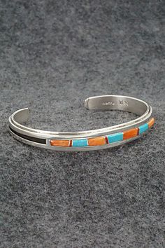 This beautiful turquoise, coral, spiny oyster and sterling silver bracelet was expertly crafted by Navajo silversmith Wilbert Muskett Jr. The inside of the bracelet is signed WM and stamped sterling.Size: 5 1/8" (will fit up to a 6 1/4" wrist)Gap: 1 1/8"Width: 3/8"Free shipping on all orders! We ship with USPS and always include tracking. All orders ship within a day of payment.Returns are accepted up to 30 days after you receive your order. Just send us a message. Our shop offers cash back or store credit. The item must be returned in new condition. Multicolor Sterling Silver Bracelet With Inlay, Multicolor Inlay Sterling Silver Bracelets, Multicolor Sterling Silver Bracelets With Inlay, Southwestern Sterling Silver Inlay Bracelet Gift, Southwestern Silver Bracelet With Multi-stone, Southwestern Silver Multi-stone Bracelets, Southwestern Silver Multi-stone Bracelet, Southwestern Multicolor Bracelets With Inlay, Bear Carving