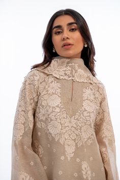 A short beige khaddi corduroy shirt with aari and tilla embroidery is paired with a matching worked organza dupatta. Playful tassel detailing complements the shirt and an embroidered rawsilk shalwar completes the look. Model Height is 5'2 and Shirt Length is 35' Beige Salwar Suit, Designer Naqshi Organza Kurta, Festive Beige Blouse Piece With Resham Embroidery, Festive Beige Blouse With Resham Embroidery, Elegant Beige Blouse Piece With Resham Embroidery, Elegant Embroidered Cambric Fabric For Wedding, Elegant Wedding Embroidered Cambric Fabric, Traditional Tissue Silk Kurta With Naqshi, Traditional Naqshi Kurta In Tissue Silk