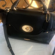 Coach Top Handle / Crossbody Leather Satchel! Carry It In Hand, In The Crook Of Your Arm Or Over The Shoulder For An Incredibly Luxe Look And Plenty Of "Where Did You Get That Bag?". Nwot And No Calls Outs On This Bag ! Shiny Gold Hardware! 4 Bottom Feet. Genuine Leather, Color: Black, Inside Multifunction Pockets; Fabric Lining Turnlock And Zip Closures; Top Handle With 4.75" Drop Detachable Strap With 22.5" Drop For Shoulder Or Crossbody Wear Approximate Dimensions: 9.5 'L 8.5 H 5.25'w Smooth Black Satchel With Cc Turnlock Closure, Black Satchel With Cc Turnlock Closure For Travel, Elegant Black Satchel With Cc Turnlock Closure, Formal Black Satchel With Cc Turnlock Closure, Everyday Black Satchel With Turn-lock Closure, Black Everyday Satchel With Turn-lock Closure, Black Satchel With Turn-lock Closure For Everyday, Black Satchel With Turn-lock Closure And Double Handle, Classic Coach Bags With Cc Turnlock Closure