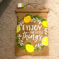 a bag that says enjoy the little things on it with lemons and leaves around it