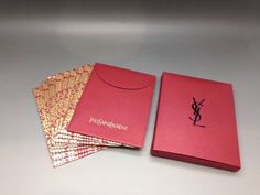 two red books sitting next to each other on top of a white tablecloth covered surface