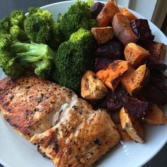 a white plate topped with chicken, potatoes and broccoli