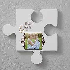 a personalized puzzle piece hanging on the wall with a couple's photo in it