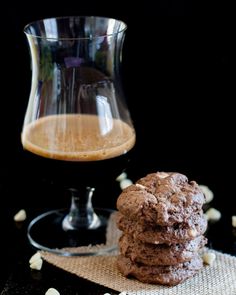 a stack of cookies next to a glass of coffee