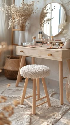 a dressing table with stools, mirror and other items on the floor in front of it