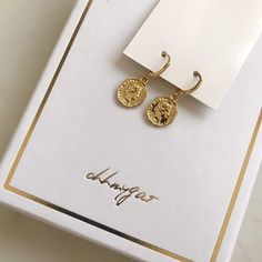 Dainty gold dangle coin earrings. These gold huggie earrings feature a tiny Italian lira coin charm. Delicate and yet eye catching. The ultimate accessory for every outfit, day to night. made of 14k gold plating over brass.Measurements:Diameter- 10mmCoin charm- 12xmm Shipping:Please allow 1-3 business days for your order to be processed and shipped. All orders are shipped in our customize box, gift ready. *Let me know if you have any questions and I will promptly respond Everyday Gold Plated Coin Jewelry, Gold Huggie Jewelry Gift For Her, Dainty Gold Earrings Gift For Her, Gold Plated Charm Earrings, Gold-plated Charm Earrings, Yellow Gold Dangle Coin Pendant Jewelry, Gold Sterling Silver Hoop Earrings For Her, Yellow Gold Dangle Jewelry With Coin Pendant, Gold Sterling Silver Hoop Earrings As Gift For Her