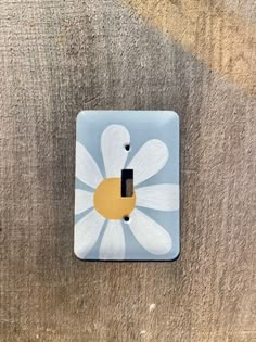 a light switch cover with a flower painted on it