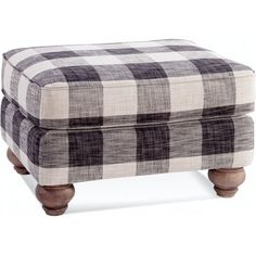 the footstool is made out of wood and plaid fabric