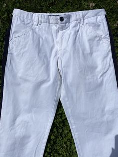 Magnificent Classic Trousers Design Dolce Gabbana, Italy 90s. White trousers with a blue side stripe in cotton. Two front pockets and three back pockets, straight leg model at the ankle, button closure and zipper. Hardware all signed. Stylish and elegant. Excellent condition. Our products can be used immediately without any problem, there is no dust, smell or anything like that. All the products in our store are 100% original and authentic. The product that will be shipped is exactly what you se Fitted Cotton Ankle-length Jeans, Fitted Ankle-length Cotton Jeans, White Fitted Chinos Casual Style, Casual Fitted White Chinos, White Fitted Casual Chinos, Cotton Bottoms With Five Pockets Ankle-length, Cotton Ankle-length Pants With Five Pockets, Fitted White Casual Chinos, Fitted White Bottoms With Hip Pockets