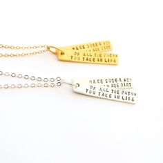 This is a beautiful hand crafted quote necklace that says "Of All The Paths You Take in Life, Make Sure a Few of Them Are Dirt" - by John Muir, also known as "John of the Mountains" and "Father of the National Parks." It's the perfect gift for any nature lover, graduate or traveler. Choose between sterling silver and 14kt gold vermeil. The quote is written on 2 bars, Each pendant measures roughly 1/4" x 1". Inspirational Adjustable Necklace For Best Friend, Inspirational Hand Stamped Necklaces As A Gift, Inspirational Hand Stamped Necklace For Gift, Inspirational Hand Stamped Necklaces For Gift, Inspirational Hand Stamped Necklace For Best Friend, Inspirational Adjustable Hand Stamped Necklace, Inspirational Hand Stamped Adjustable Necklace, Inspirational Stamped Necklace For Gifts, Inspirational Hand Stamped Necklace For Mom