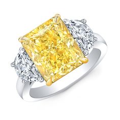 a yellow diamond ring with three diamonds on it