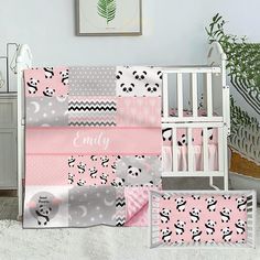 a baby crib bedding set with pink and gray panda bears