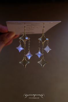 "---- Welcome to CiaoQiao Shop ----- The earrings feature geometric star-shaped moonstone and lemon quartz natural gemstone beads. Each earring consists of a sequence of these stars, with the largest at the top and gradually decreasing in size towards the bottom. The beads are of a reflective gemstone with a multifaceted surface, creating a shimmering effect as they catch the light.  Length including hooks: 2 1/2\" | 6.35cm What does \"14k gold filled\" mean? \"Gold-filled\" is a USA industry st Celestial Star-shaped Crystal Earrings For Gift, Celestial Star-shaped Crystal Earrings Gift, Celestial Star-shaped Crystal Earrings, Raspberry Jewelry, Firefly Jewelry, Stars Earrings, Celestial Earrings, Gothic Earrings, Witchy Jewelry