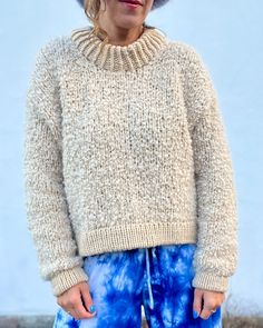 an older woman wearing blue and white tie dye pants with a hat on her head