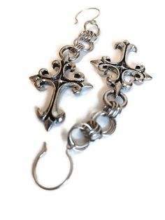 ~ Limited Edition Original Design from Mary @ Vexed! ~ Lovely gothic fleur design crosses plated in antique silver ~ Strung up by stainless steel linked rings ~ Earrings measure 4 inches long VEXED JEWELRY: SPOOKY, BLASPHEMOUS, ONE-OF-A-KIND AND LIMITED EDITION HANDCRAFTED JEWELRY MADE WITH LOVE, SPITE, CARE, BLOOD, SWEAT, TEARS, EXPERTISE & TOP QUALITY MATERIALS SINCE 2007! Gothic Hypoallergenic Metal Jewelry, Gothic Silver Surgical Steel Earrings, Antique Silver Earrings, Gothic Crosses, Linking Rings, Victorian Gothic, Original Design, Favorite Things Gift, Handcrafted Jewelry