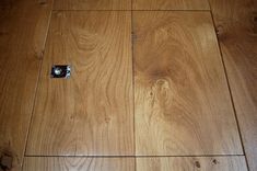 a wooden floor that has some kind of camera on it's side and is laying on the ground