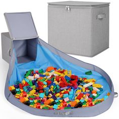 a large gray box filled with lots of legos next to a grey storage container