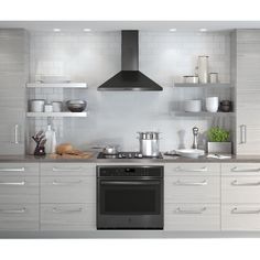 a stove top oven sitting inside of a kitchen next to white cupboards and shelves