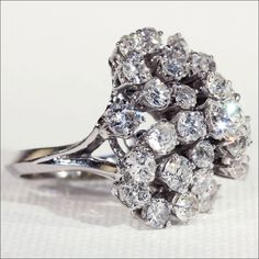 a diamond cluster ring on a white background