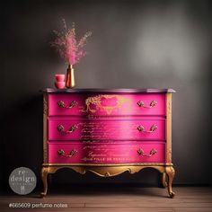 a pink and gold dresser with flowers on top