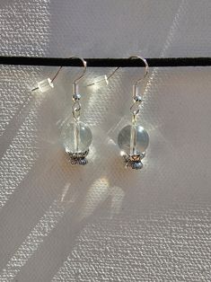 Crystal ball earrings with quartz beads, plastic beads, and sterling silver hooks Adjustable White Crystal Earrings, Adjustable Round Crystal Earrings, Silver Crystal Earrings With Faceted Beads, Silver Faceted Round Crystal Earrings, Crystal Ball Earrings, Plastic Beads, Crystal Ball, Jewelry Earrings Dangle, Etsy Earrings