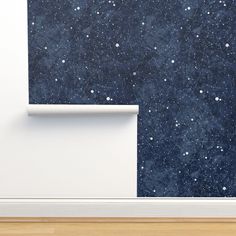 an empty room with a space themed wallpaper