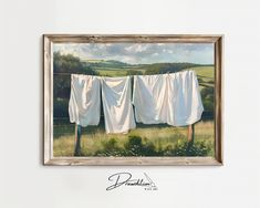 an oil painting of clothes hanging on a line in front of a field and hills