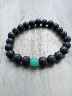 This is a beautiful piece of jewelry, a UNIQUE and original Gift for Her and Him ! Adjustable, please let me know if you need a specific length. The Elastic Bracelet length is about 8 inches and the beads size are 8mm. This bracelet is made of : -Black Lave stone (natural stone) -Green Matte Glass Beads Don't hesitate to contact me if you have any questions! Please be aware that while we do our best to photograph the colors true to life, all monitors display colors differently. Please allow some Casual Lava Stone Beaded Bracelets As Gift, Casual Stretch Bracelet With 8mm Beads As Gift, Casual Stretch Bracelet With 8mm Beads For Gifts, Green Beaded Bracelets For Meditation, Casual Lava Stone Jewelry Gift, Green Stretch Bracelet For Meditation, Casual Lava Stone Beaded Bracelets, Handmade Green Spiritual Stretch Bracelet, Green Natural Stones Beaded Bracelet For Meditation