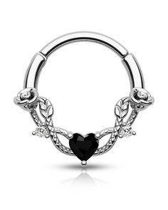 a black heart shaped nose ring with leaves on the sides and an oval design around it