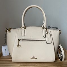 100% Authentic Brand New With Tags Coach 79316 Pebble Elise B4/Ivory And Gold Hardware Approximate Measurements: 9.5”Bottom, 12"Top (L) X 8.5" (H) X 4" (D) Handles With 5.5" Drop Long Strap Included Classic Cream Satchel For Work, Elegant Neutral Satchel With Removable Pouch, Cream Coach Bags For Office, White Satchel With Detachable Strap For Work, White Top Handle Satchel For Work, Elegant White Satchel For Workwear, Elegant White Satchel For Work, Classic Cream Satchel, Chic Beige Coach Satchel