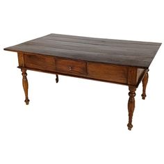 an old wooden table with two drawers on one side and three legs on the other