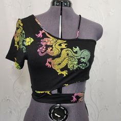 Details: - Rainbow Dragon Design - Short Sleeve - Off-The-Shoulder Design - Cropped - Lightweight - Stretch - Nwt ( New With Tag) Brand: Love J Size: L ( Fits Like A Medium) Approx.: 16" Pit To Pit 15" Length 10" Sleeve Comment For More Details! Don’t Be Shy! Send Me Offers!!! Bundle Items For Better Deals I Can Ship All Items Out A.S.A.P Please Read Descriptionto Help Form Your Own Opinion On The Items Condition. Thanks, Anna =) Shop My Closet For: Boho Bohemian Hippie Tie Dye Spring Summer Seq Trendy Black One Shoulder Top For Summer, Casual Black One Shoulder Top For Spring, Black One Shoulder Crop Top For Summer, Yellow One Shoulder Top For Summer, Black One-shoulder Crop Top For Summer, Black Fitted One Shoulder Top For Summer, Fitted Multicolor One Shoulder Top, Fitted Green One Shoulder Top For Summer, Yellow Fitted Off-shoulder Tops