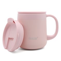 a pink coffee cup with a lid next to it