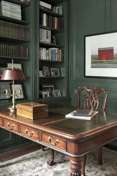 a wooden desk sitting in front of a book shelf filled with books