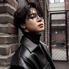 a mannequin wearing a black leather jacket leaning against a brick wall