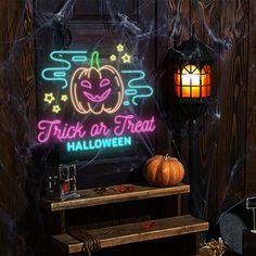 there is a neon sign that says trick or treat halloween