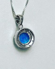 "Blue Opal Halo Necklace Minimalist and Dainty Necklace Metal: All components are made from solid .925 Sterling Silver Stone: 8mm Lab Created Opal; Cubic Zirconia Measurement: Pendant Height is 19mm (0.75\") including bail and 13mm (0.51\") wide Choose Chain Length Please feel free to Convo me with any questions before purchasing. Please view policy before purchasing Other Opal Necklaces can be found here https://www.etsy.com/shop/LinksAndStones?ref=ss_profile&section_id=24284450 Thank You F Nickel Free Round Pendant For Formal Occasions, Nickel-free Round Pendant For Formal Wear, Nickel-free Round Pendant For Formal Occasions, Formal Nickel-free Round Pendant Jewelry, Formal Sterling Silver Necklace With Round Stone, Nickel-free Round Necklaces For Formal Occasions, Formal Round Nickel-free Necklaces, Formal Nickel-free Round Necklaces, Sapphire Round Pendant For Anniversary