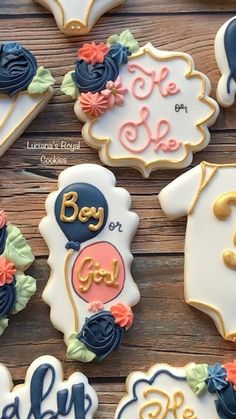 decorated cookies with the words boy or girl written in gold, blue and white frosting