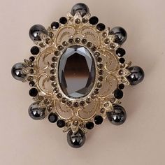 Vintage Ornate Gilded Brooch with Onyx  Has some ware. All the stones are in place. Victorian Jeweled Brooches For Party, Silver Jeweled Brooches For Formal Occasions, Antique Black Brooches For Evening, Antique Black Brooch For Evening, Formal Silver Jeweled Brooches, Black Brooch Jewelry For Wedding, Antique Black Evening Brooch, Silver Jeweled Brooches For Evening, Victorian Jeweled Formal Brooches