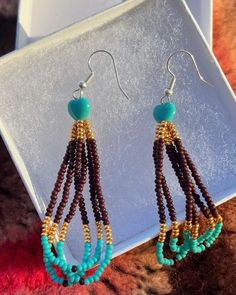 Beautiful handmade beaded teal, brown, and gold hoop dangle earrings. Brown Teardrop Beaded Earrings With Colorful Beads, Brown Teardrop Beaded Earrings, Handmade Brown Dangle Jewelry, Brown Hoop Earrings With Ear Wire For Gift, Unique Brown Hoop Earrings For Gift, Unique Brown Beaded Earrings As Gift, Bohemian Brown Hoop Earrings, Bohemian Brown Beaded Earrings For Gift, Brown Bohemian Hoop Earrings