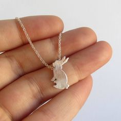 A cute handmade little rabbit necklace for bunny lovers or to remember a loving pet. Handmade with High quality Sterling silver and Sterling silver chain. - This is a perfect gift for pet and bunny lovers or a special gift to remember the memories shared with a loving pet. - The necklace in the pictures is 16'' size. - Available in sizes 15'' to 30''. - CHECK YOUR SIZE measuring your neck with a string or yarn. - Your necklace arrives beautifully packaged and is ready to gift. - One necklace. MA Handmade Cute Sterling Silver Charm Necklaces, Handmade Cute Charm Necklaces, Cute Pendant Charm Necklace For Gift, Cute Handmade Charm Necklaces For Birthday Gift, Cute Handmade Everyday Charm Necklaces, Cute Charm Necklaces For Gifts, Cute Everyday Handmade Charm Necklaces, Cute Handmade Sterling Silver Necklaces, Cute Round Pendant Charm Necklaces As Gifts